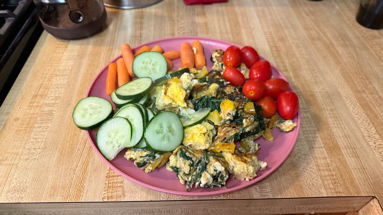 Eggs, greens, cucumbers and tomatoes